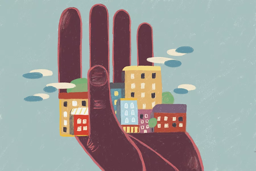 The illustration shows a human hand supporting or encircling a small cluster of colourful city buildings and houses.